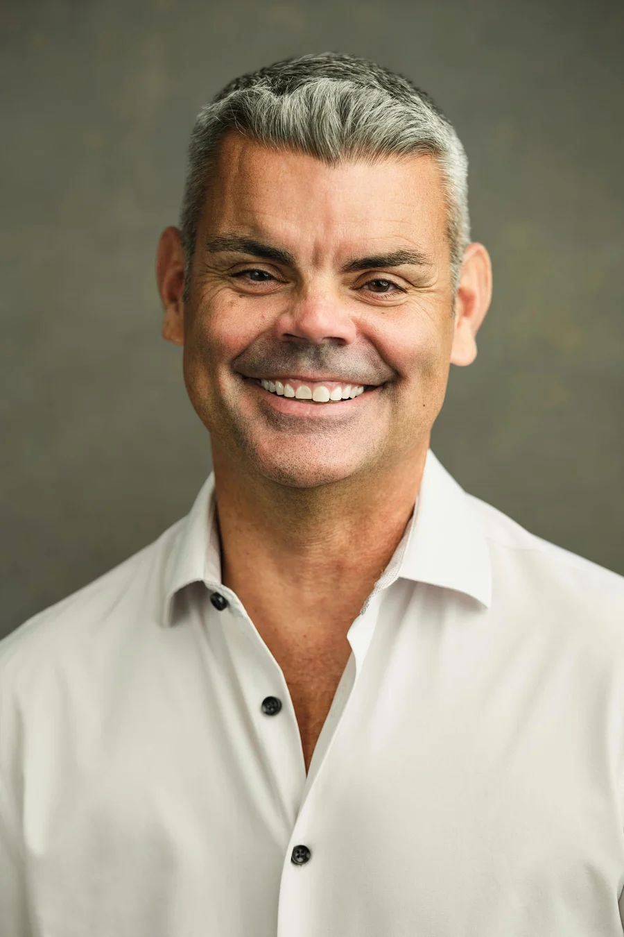 Daniel McLaughlin photographed on Johnson & Krol’s green backdrop at its Des Peres office