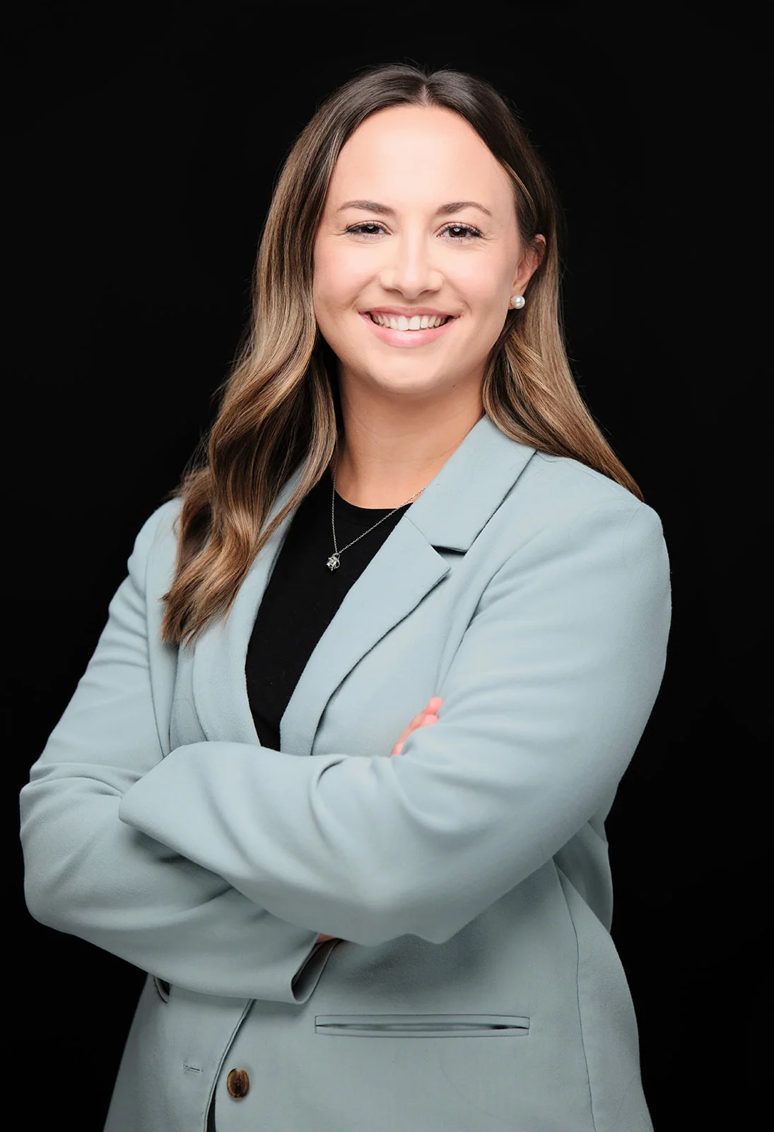 Woman in a pale blue blazer with arms crossed, by Henry David Photography