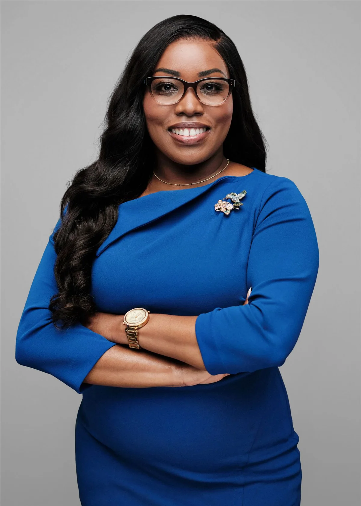 Woman wearing glasses and a royal blue dress, by Henry David Photography