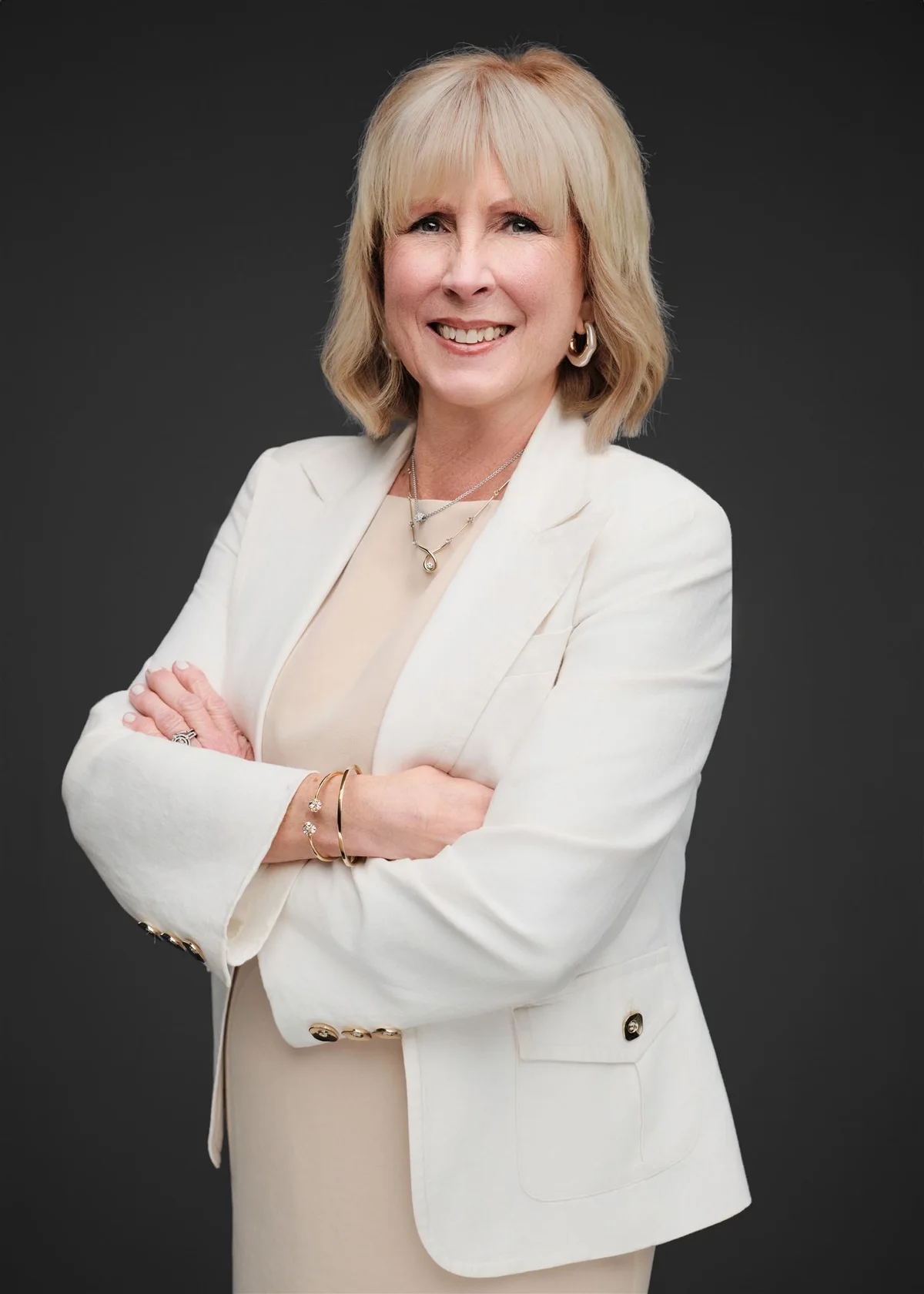 Woman smiling in a white blazer, by Henry David Photography