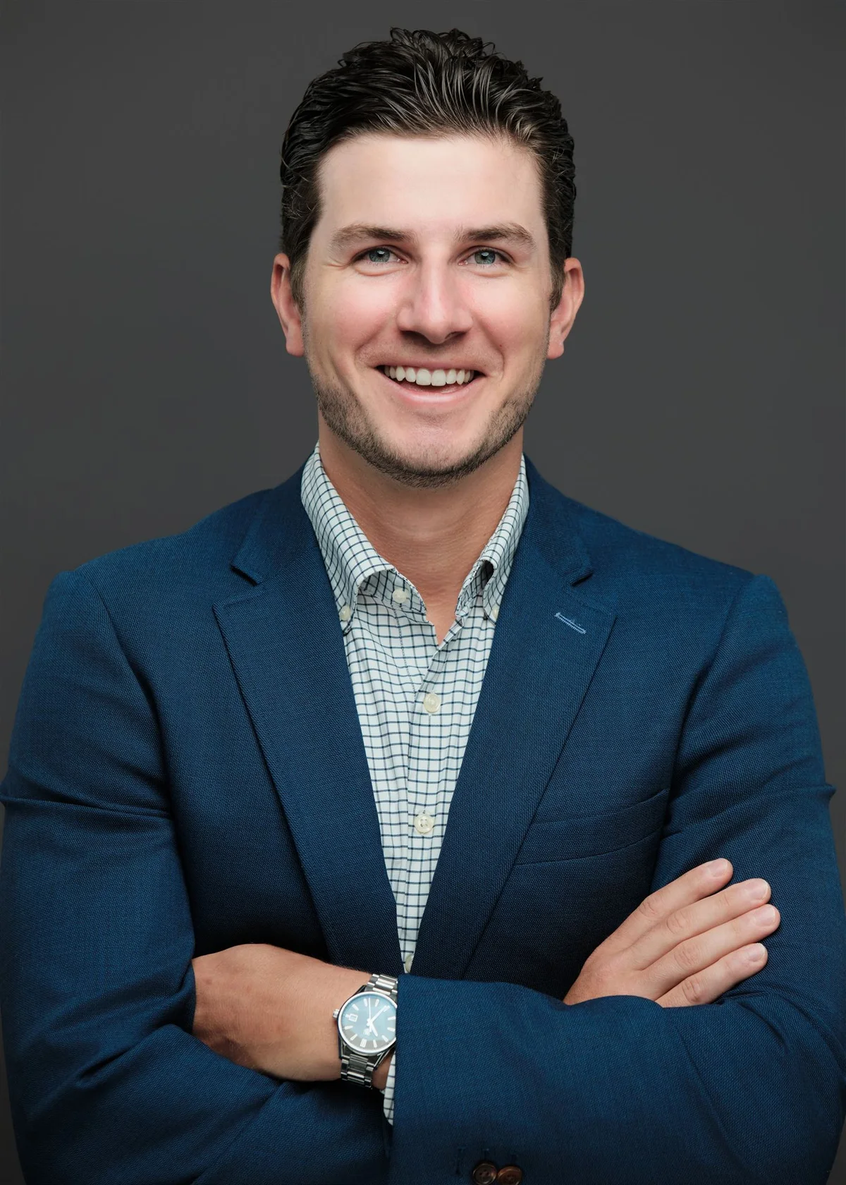 Smiling professional in a navy blazer, photographed by Henry David Photography