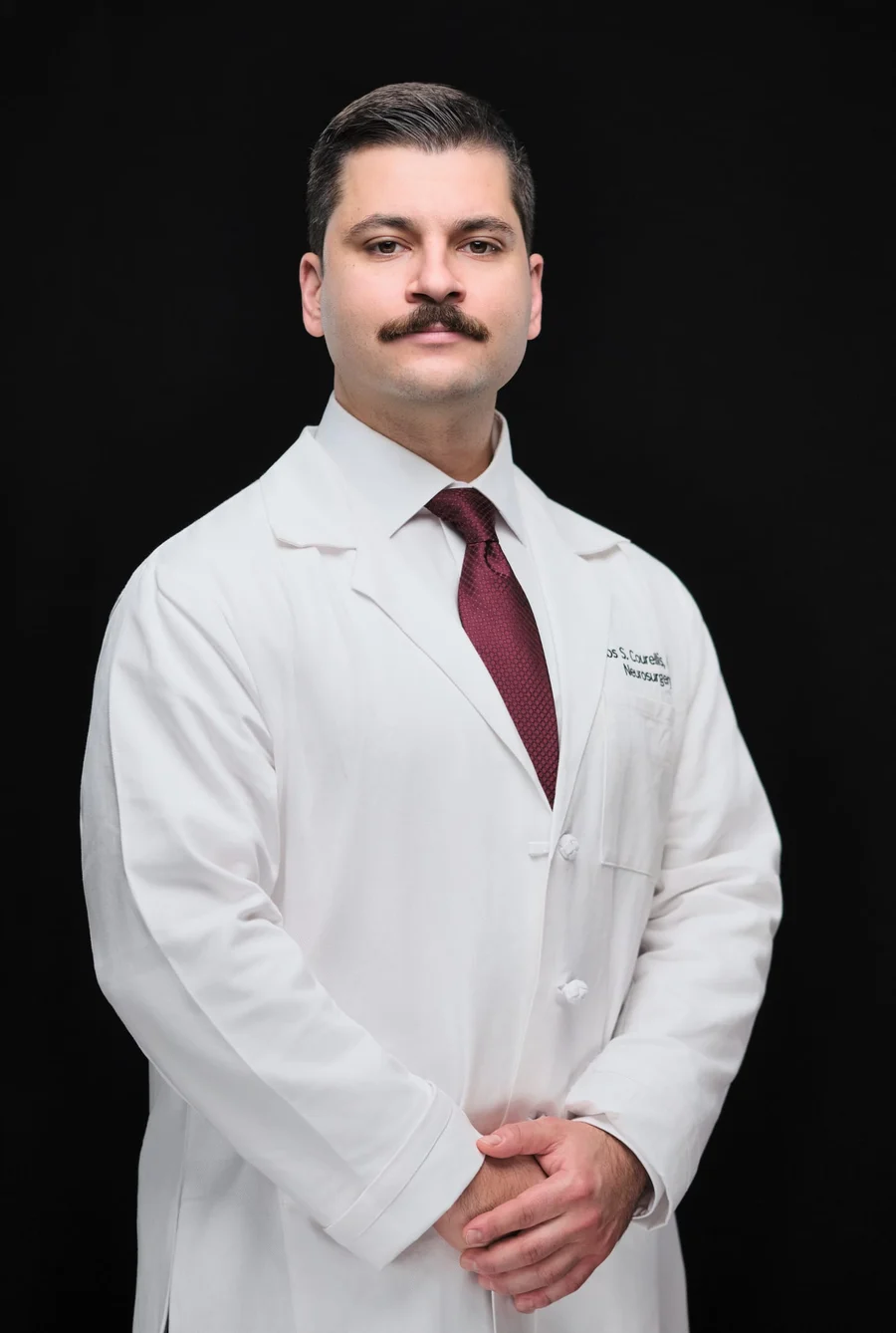 WashU neurosurgery team member in a white coat, photographed by Henry David Photography in St. Louis